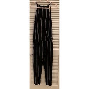 Olivaceous black and white striped jumpsuit.